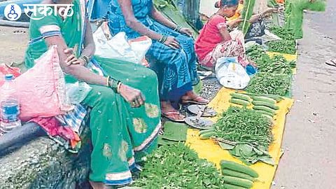 Women selling small quantity of wild vegetables in weekly market.