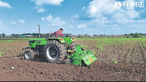 Farmer Harshad Holkar rotating the rotor on soybean crop
