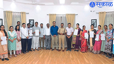 Collector Ayush Prasad next to Superintendent of Police M Rajkumar while giving certificates of appointment to nine compassionate persons in the police force.
