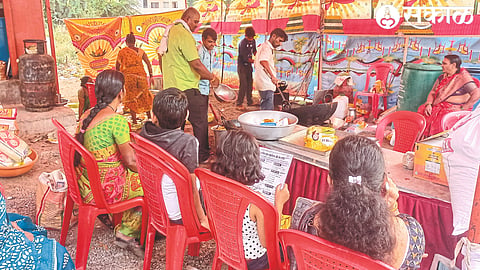 At Satananaka (Malegaon) women and men sitting by numbers to get snacks prepared by the chef.