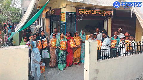 Nitin Sapke giving happy ration to the beneficiaries at the ration shop in Hari Vitthal Nagar-2.
