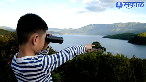 Boy Pointing towards River
