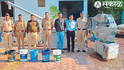 Deputy Superintendent of Police Sachin Hire, Assistant Inspector Jayesh Khalane and colleagues with the machinery seized from the fake 'DEF' factory. 18 lakh bucket printing machine in the second photo.