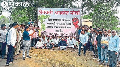 Farmers holding placards of 'Leaders' village ban'.