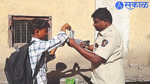 ST bearer Umaji Wadile and student Kundan Pawra while rescuing a pigeon stuck in the net of a kite.