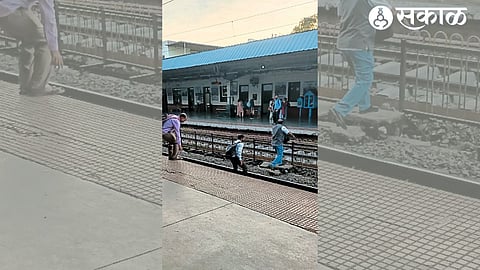 Passengers crossing the tracks at a railway station.