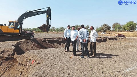 Kiran Patil, Zilla Parishad member of Kapdane group, while inspecting the foundation excavation and inspection in Panjra riverbed by Poklen machine.