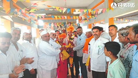 Various officials felicitating Janardhan Bairagi.