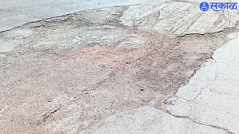 pothole on the road in front of the Bazar Samiti entrance.