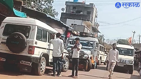 Vehicles parked awkwardly on the main market road.