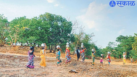 Women walking through the valley for drinking water.