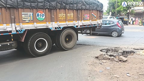 A pothole caused by a heavy vehicle breaking the concrete on the gutter.