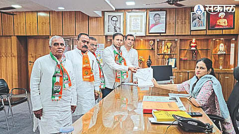 While filing nomination form with District Election Officer Manisha Khatri Congress candidate Adv. Gowaal Padavi.