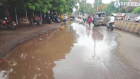 Rainwater accumulated on the road leading to the camp at Malegaon.