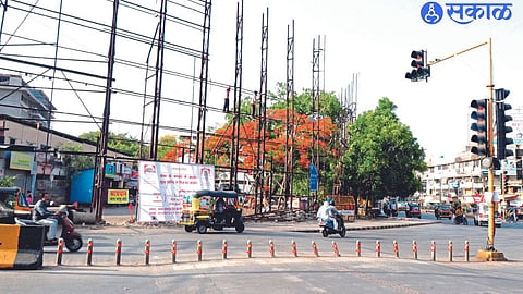 Workers removing hoardings from Old Central Bus Stand area.