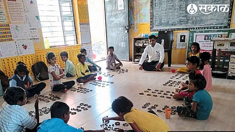 Active teacher Bhayyasaheb Salunke while teaching children in 'Sandhya School' activity at Zilla Parishad Primary School.