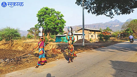 women carry water through Handa