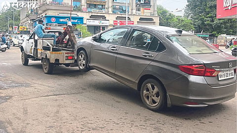 Workers towing the parking lot on Pandit Colony road