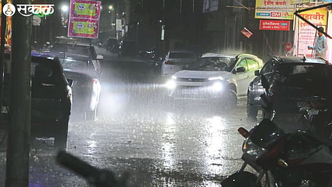 Heavy rain started in the city around 7 pm on Monday. A car driving through the road in the rain.
