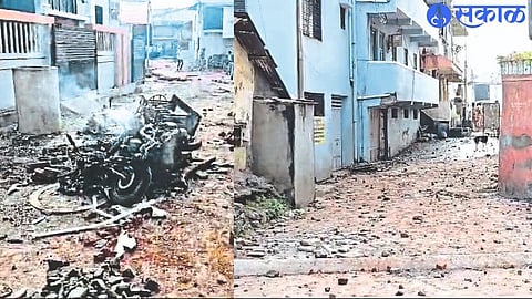 Burnt motorcycle & stone-brick block lying in the street in Maliwada area.