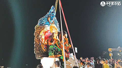 Mandal workers during immersion of Durga Devi idol in Mehrun lake on Sunday evening.