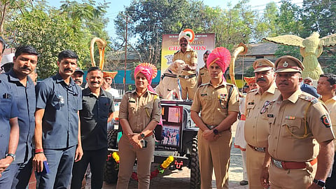 Surya proudly holds his gold medal for explosive detection at the All India Police Meet, demonstrating excellence in law enforcement skills.