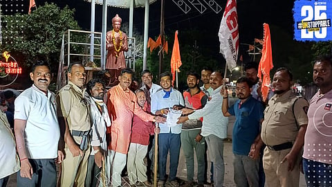 Prahar activists march with torches demanding justice and loan waiver for distressed farmers.