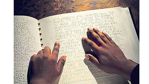 ब्रेल लिपीतील पुस्तकाचे वाचन करताना अंध व्यक्ती