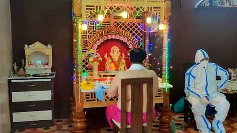 wearing ppe kit to welcome of ganesh pujan at people home in dapoli