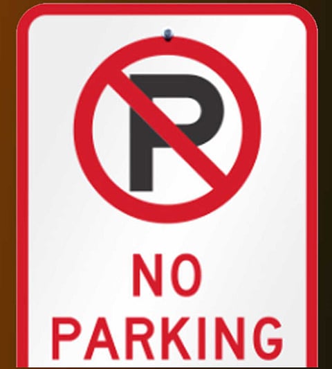 Vehicles are parked on the narrow streets of the city markets