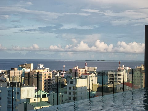 Maldives Male's skyline from an infinity pool. For many Maldivian youth, the ‘Emirati lifestyle’ beats a hard day’s work.
Photo: Neil Merret