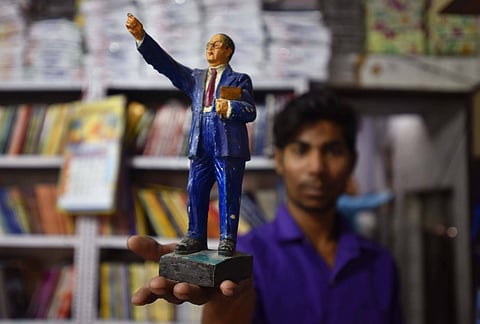 A shopkeeper in Delhi with a statuette of B R Ambedkar for sale. Six new books on Ambedkar examine his life and thought with sincere reverence as well as honest critique.