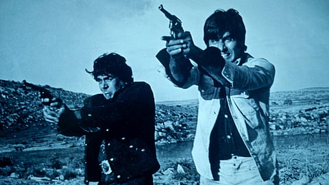 A still from the Hindi blockbuster Sholay, starring Dharmendra (left) and Amitabh Bachchan (right). As the film turns 50, it remains emblematic of an India that was aware of but did not confront its deep social schisms, which have since fragmented its citizenry.