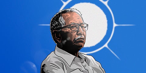 Illustrated portrait of Dalpat Chauhan with glasses and a moustache, shown in three-quarter profile against a blue background with a bright white circular halo-like sun behind his head.