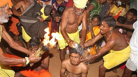 திண்டுக்கல் மாவட்டம் கொடைரோடு அருகே ஜெ.ஊத்துப்பட்டியில் நடந்த கோயில் விழாவில் பக்தர்களின் தலையில் தேங்காய் உடைத்து நேர்த்திக்கடனை நிறைவேற்றும் பூசாரி.