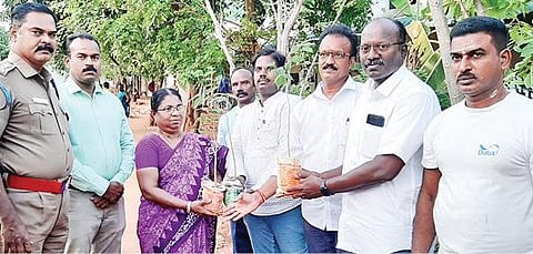 திருச்சி சிறப்பு முகாமில் இலங்கை தமிழர் மகேந்திரனால் வளர்த்து தானமாக அளிக்கப்பட்ட மரக்கன்றுகளுடன் அரசு அதிகாரிகள் மற்றும் தண்ணீர் அமைப்பினர்.