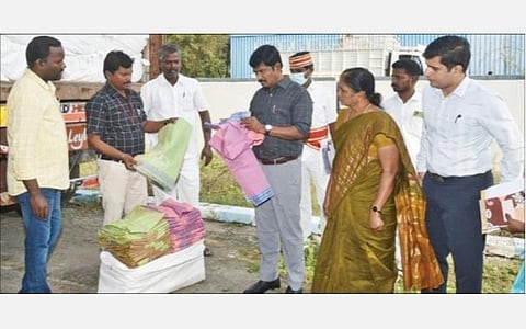 திண்டிவனத்தில், விலையில்லா வேட்டி, சேலைகளை ஆய்வு செய்யும் ஆட்சியர் மோகன்.