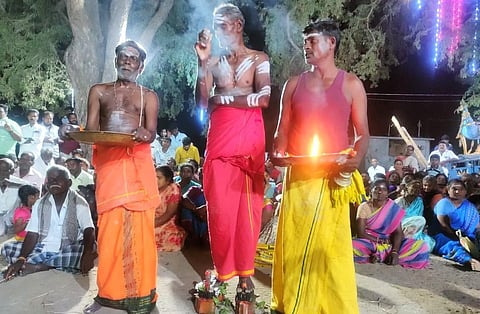 திருவெண்ணைநல்லூர் அருகே ஒட்டனந்தல் கிராமத்தில் ரத்தினவேல் முருகன் கோயில் பூசாரி ஆணி பதித்த காலனியின் மீது ஏறி நின்றபடி எலுமிச்சை பழங்களை ஏலம் விடுகிறார்.
