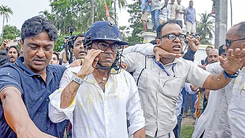 மேற்கு வங்கத்தின் சோனார்பூரில், தேர்தலுக்கு பிந்தைய வன்முறையால் பாதிக்கப்பட்ட வர்களை நேற்று சந்திக்கச் சென்ற திரிணமூல் காங்கிரஸ் எம்.பி. அபிஷேக் பானர்ஜி மீது கற்கள், முட்டைகள் வீசப்பட்டன. இவற்றிலிருந்து பாதுகாத்துக் கொள்ள அவர் ஹெல்மெட் அணிந்து கொண்டார். படம்: பிடிஐ