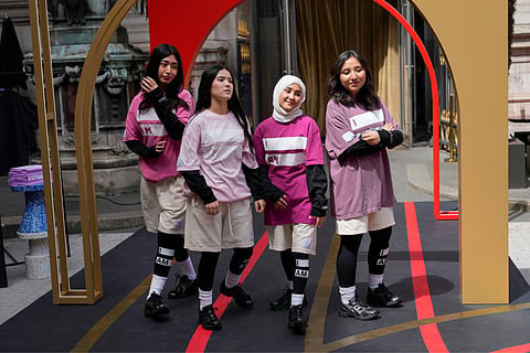Ayenda formally known as Afghanistan youth, wear creations by 4TheWalk and Sneex footwear, during the first gender equal Olympic Games fashion show, at the 2024 Summer Olympics in Paris, Sunday (July 28) To celebrate gender equality at the Olympics, PARITY Paris hosted a runway show in conjunction with the Coca-Cola House