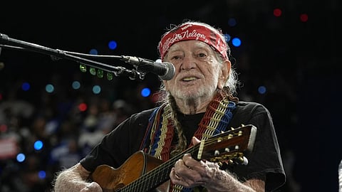 Musician Willie Nelson performing at an event