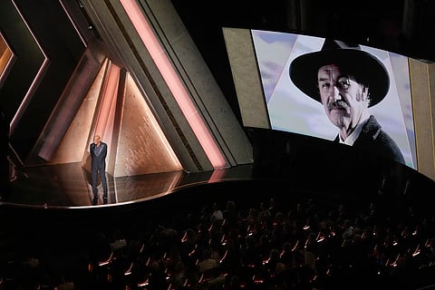 Morgan Freeman speaks about Gene Hackman with an image of Gene Hackman on the screen during the Oscars on Sunday, March 2, 2025, at the Dolby Theatre in Los Angeles