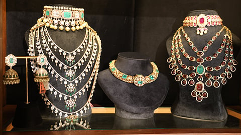 Necklaces designed by Nilaya Reddy, glowing subtly under soft light.