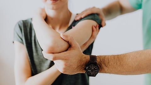 Man helping woman with arthritis