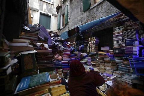 Volunteers pile up damaged books from renowned bookstore 'Acqua Alta' (High Water) after flooding in Venice, Italy (AP Photo/Luca Bruno)