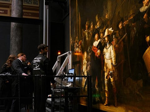 Technicians and researchers study Rembrandt's Night Watch masterpiece (AP Photo/Aleksandar Furtula)