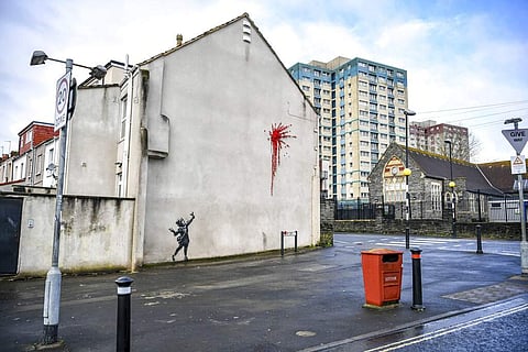 Banksy's work at a Bristol home (Ben Birchall/PA via AP)
