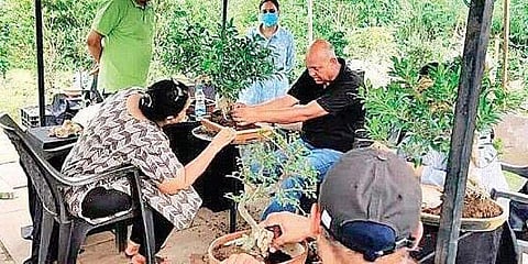 Saumik Das (in black) conducting a bonsai workshop