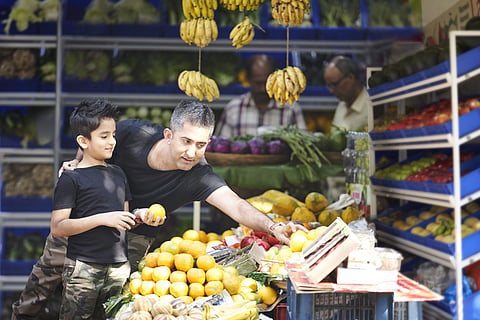 Indian father buying vegetables with his son Pic: Avinash Gowariker)