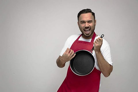 Chef Saransh Goila poses with a frying pan from Delishaas